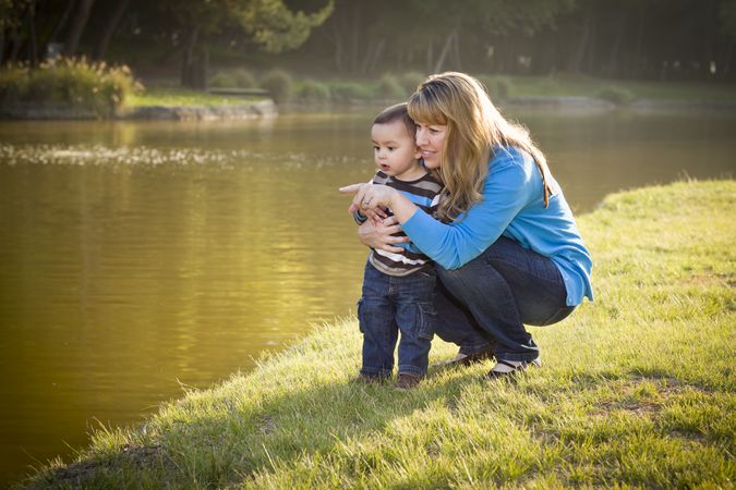 Happy Mother and Baby Son Looking Out At Lake