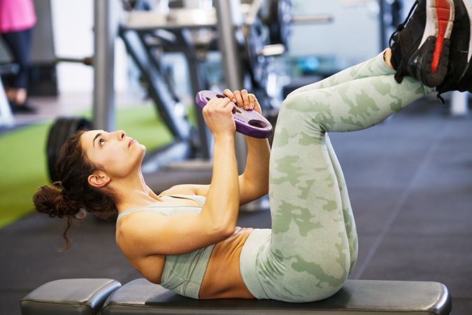 Woman exercising her abs in gym