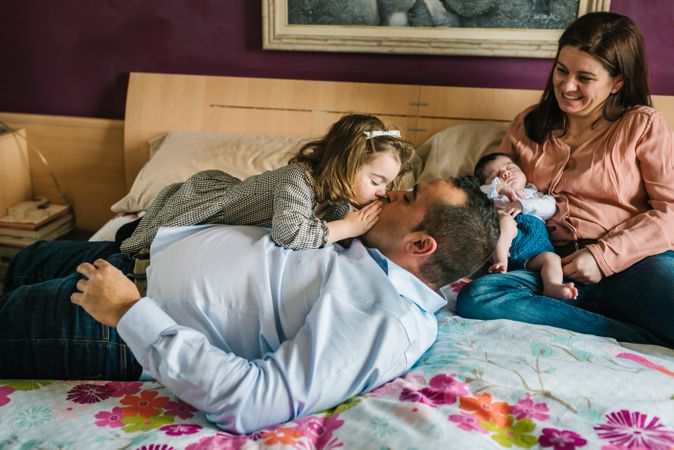 Happy family having fun in bedroom
