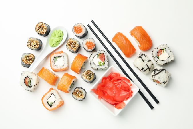 Delicious sushi rolls on plain background, top view. Japanese food
