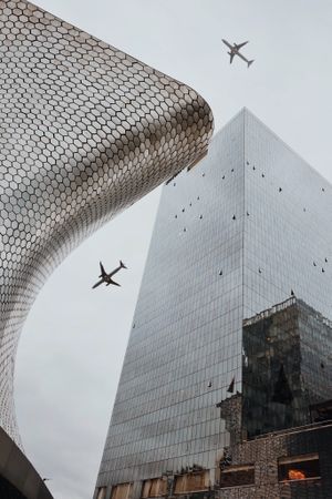Airplane flying over Soumaya Museum in Mexico