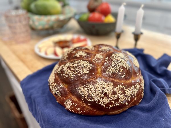Homemade braided challah bread in traditional round shape for Rosh Hashanah holiday