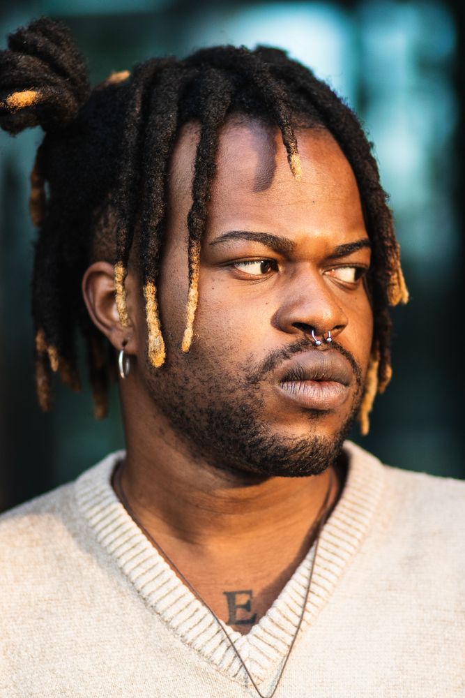 Modern man with dreadlocks and in accessories