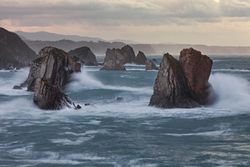 Storm with blustering waves on rocky coast