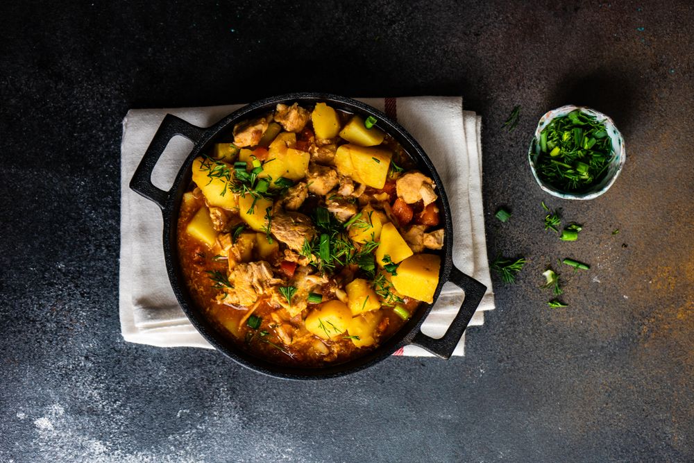 Top view of Georgian meat and vegetable stew Souzi served with herb, with space for text