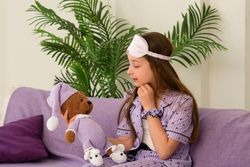 Girl gazing affectionately at teddy bear