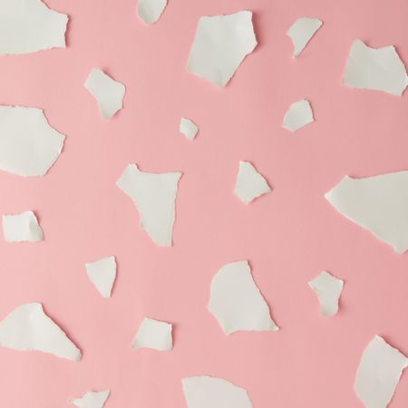 Pieces of ripped pastel colored paper in pattern