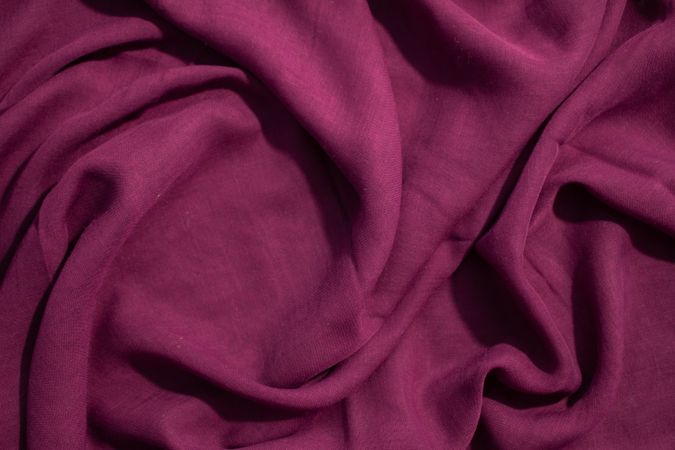 Soft purple fabric wavy spiral crumpled background abstract with copy space in the center