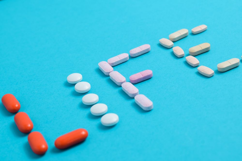 Close up of various pills making the word "LIFE"