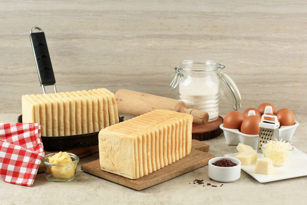 Two loads of bread with eggs, cheese and flour