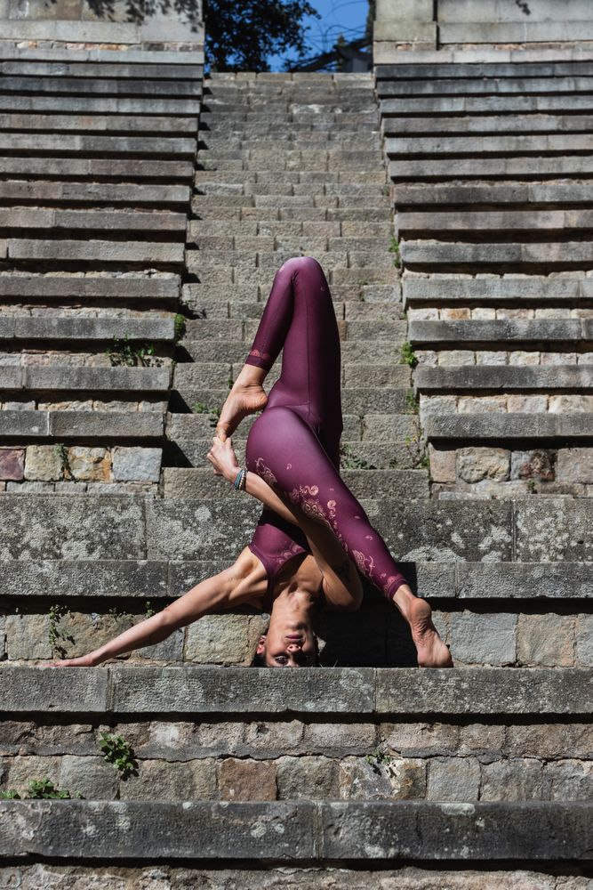 Flexible woman doing yoga in advanced pose