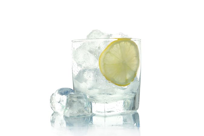Rocks glass full of ice with lemon slice