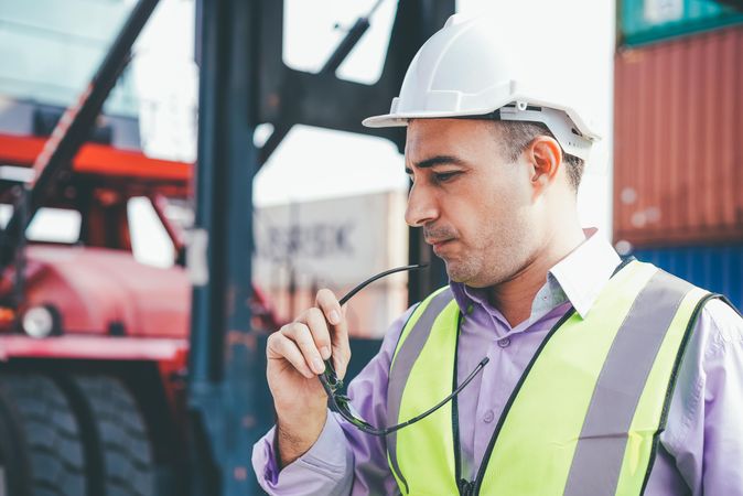 Man at work on construction site holding glasses