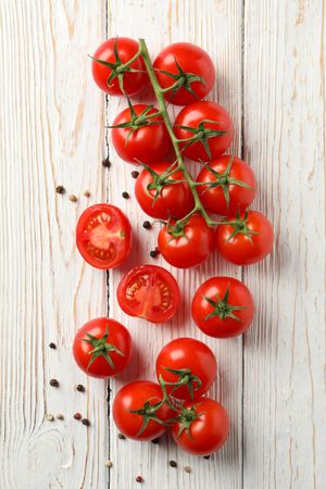 Tomatoes and pepper on wooden background, top view