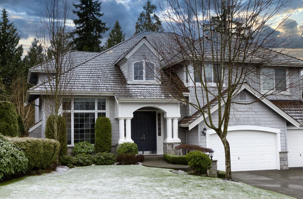 Home and lawn with early season snow dusting