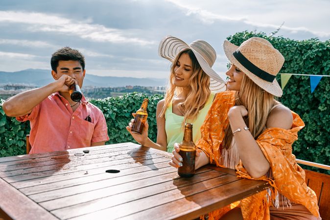 a group of young people having a good time in a summer day and cheering with beer