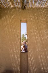 man behind stone wall