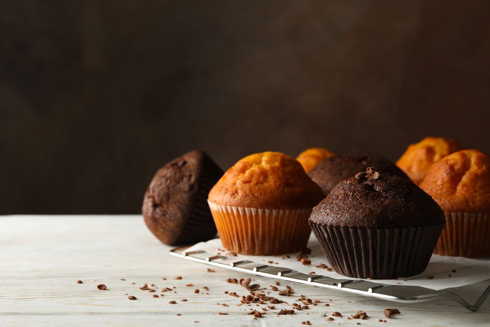Composition with tasty muffins on wooden background