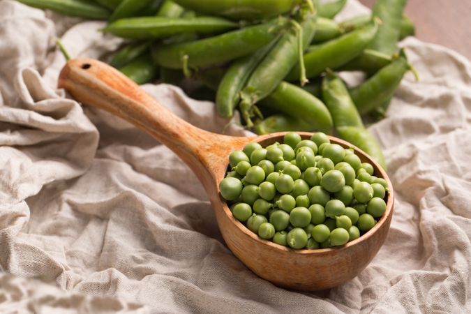 Peas in a wooden scoop
