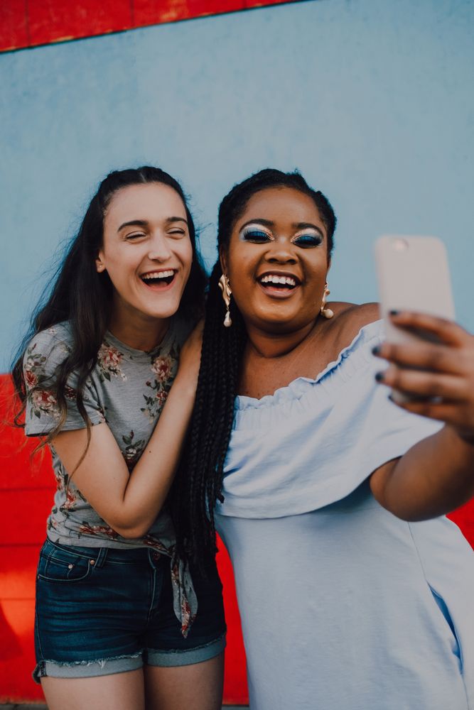 Smiling multiethnic women taking selfie