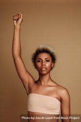 Black woman standing with her fist raised above head 4MKQl0
