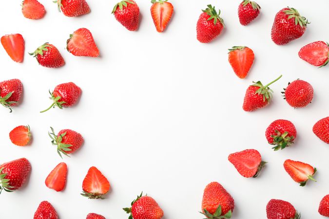 Flat lay composition with strawberries on light background, space for text. Summer sweet fruits and berries