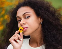Black female with yellow flower