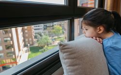 Sad girl looking out the window