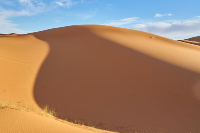 Sand dunes and blue sky with sun