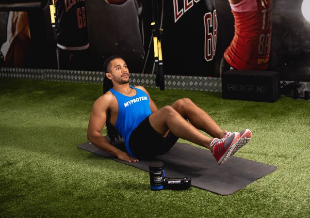 Man doing abs workout on Pilate in gym