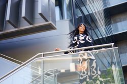 Dancer performing from urban stairs on a financial building
