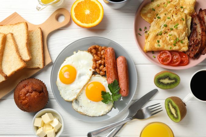 Full breakfast with eggs, beans, sausage, fruit and orange juice