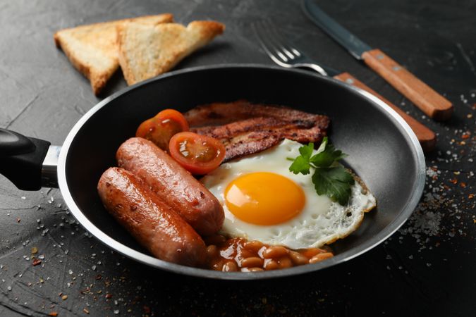 Pan of breakfast with eggs, tomatoes, sausage and bacon
