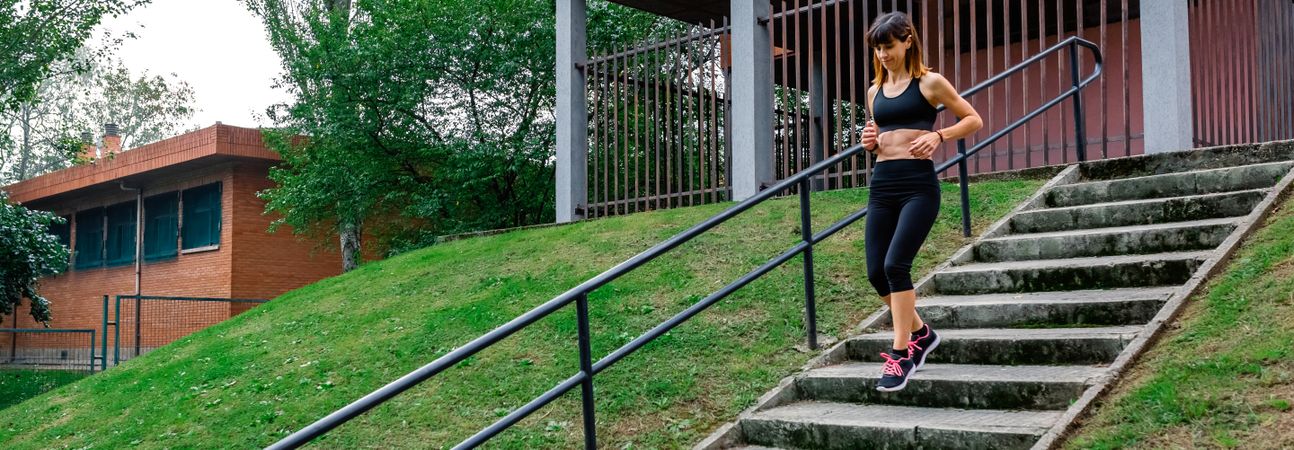 Female athlete going down stairs outdoors