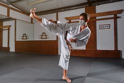 Male in mask demonstrating Krav Maga pose