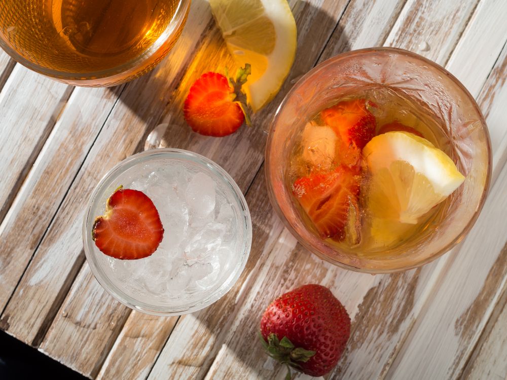 Glass of refreshing strawberry drink in daylight