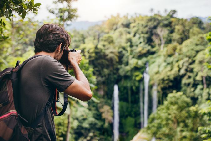 Man taking photos of the rain forest