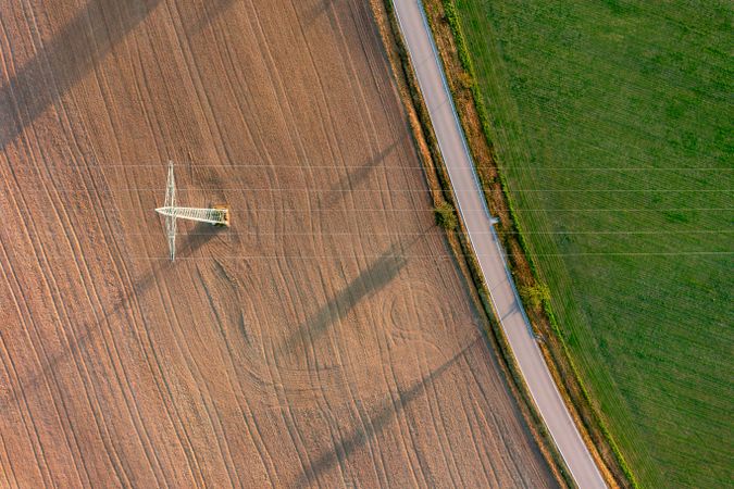 Electricity pylon aerial view at sunrise in a german village