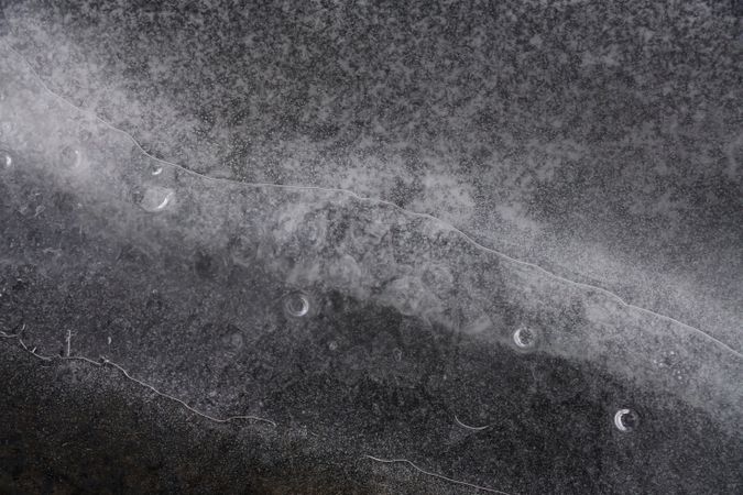 Fragment of thin ice on dark frozen river