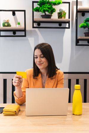 Happy woman making payment during online shopping