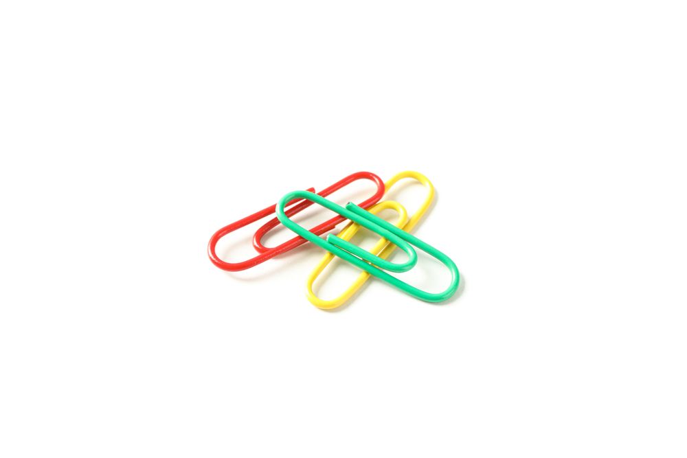 Color paper clips isolated on plain background
