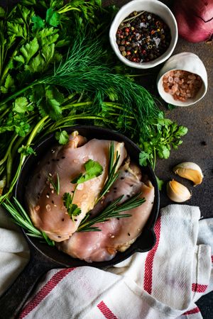 Raw chicken with rosemary sprig with seasoning
