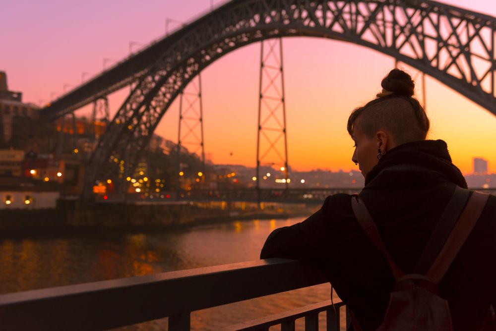 Female standing on embankment during sundown