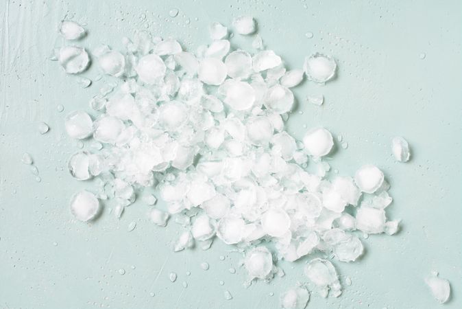 Scattered crushed ice on baby blue background