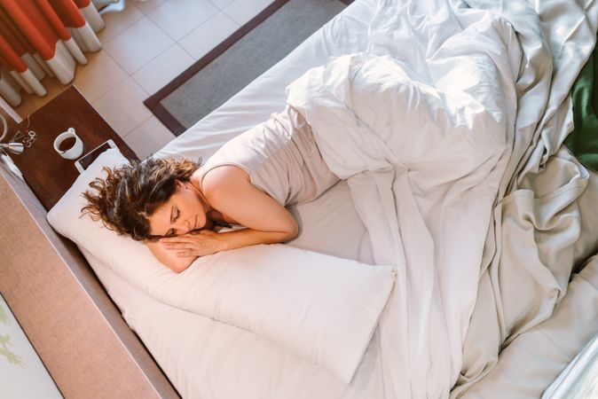 Woman dozing in bed after breakfast