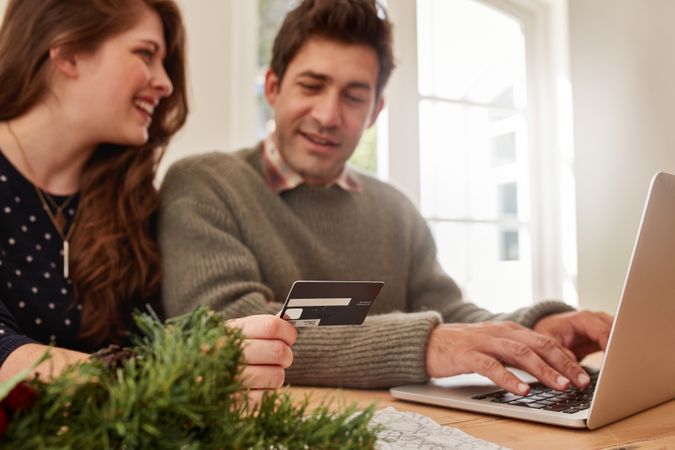 Couple shopping online at home for Christmas