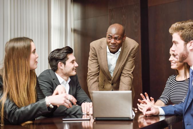 Black man leading his colleagues in a brain storming meeting at work