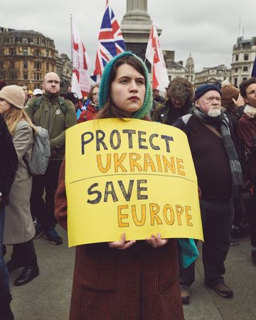 London, England, United Kingdom - March 5 2022: Woman with yellow sign at a protest in the UK