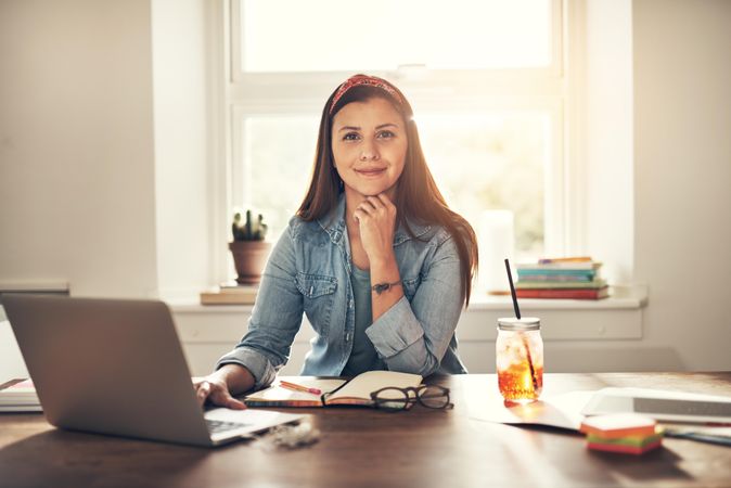 Confident woman working on laptop in home office
