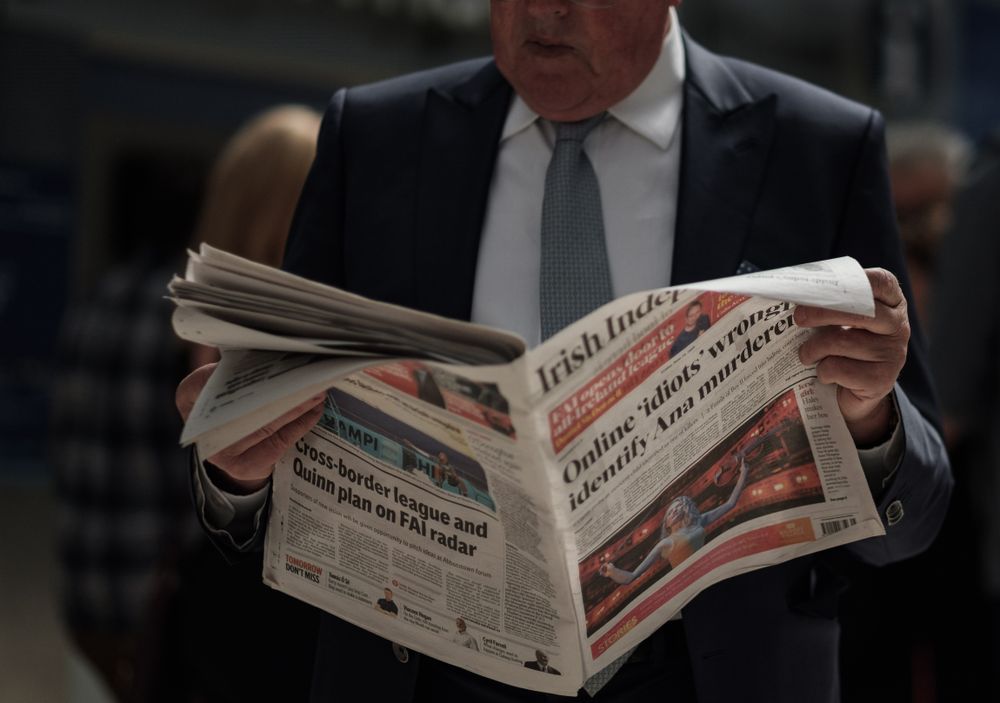 Man in suit reading newspaper